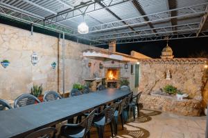 a large table and chairs in a room with a fireplace at Finca el Placer in Ulldecona