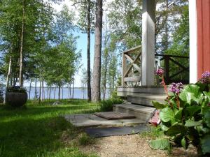 a porch of a house with a view of the water at Strandkulla in Pjelax +3 photos