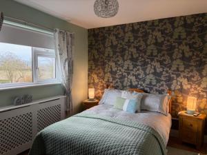 a bedroom with a bed and a window at Tess's Guest House R95K6N1 This Property is unsuitable for children under 12 years old in Freshford