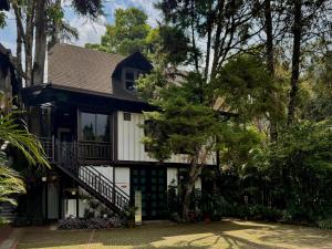 a house with a staircase on the side of it at Cameron Highland Retreat in Tanah Rata