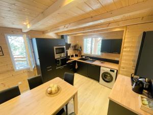 a kitchen and dining room with a table and a dining room gmaxwell at Le Chalet aux Biches in Bolquere Pyrenees 2000