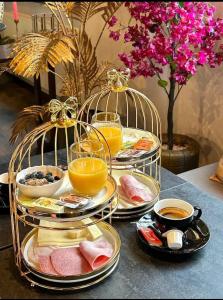 a table with three plates of food in bird cages at sevenDays Hotel BoardingHouse Mannheim in Mannheim