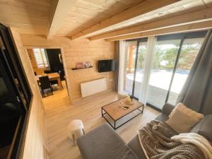 a living room with a couch and a table at Le Chalet aux Biches in Bolquere Pyrenees 2000
