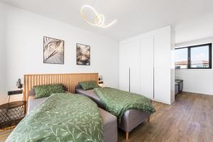 a bedroom with two beds with green sheets at Villa K&L Pasohlávky in Pasohlávky +47 photos