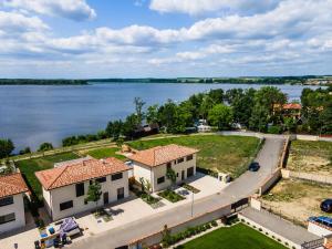 an aerial view of a house next to a lake at Villa K&L Pasohlávky in Pasohlávky