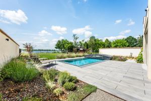 a backyard with a swimming pool and a wooden deck at Villa K&L Pasohlávky in Pasohlávky