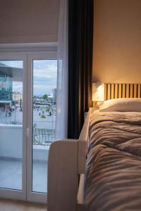a bedroom with a bed and a sliding glass door at BEDS&ROOMS TIBURTINA - Beds, Posti letto in Rome