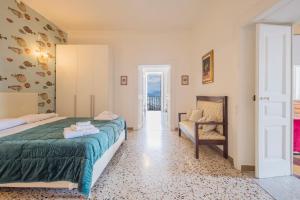 a hotel room with a bed and a chair at Residence Mareluna - Amalfi Coast by Mareluna Hotel in Vietri sul Mare