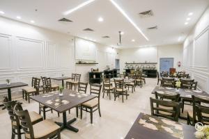 a restaurant with tables and chairs in a room at فندق امضاء النزيل المدينة المنورة in Medina