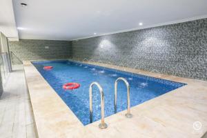 a swimming pool with two red frisbees in it at فندق امضاء النزيل المدينة المنورة in Medina