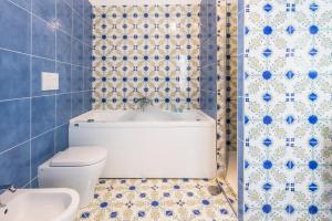 a bathroom with a toilet and a bath tub at Residence Mareluna - Amalfi Coast by Mareluna Hotel in Vietri sul Mare +52 photos