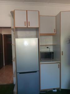 a kitchen with a refrigerator and a microwave at Duminy Guesthouse in Bellville
