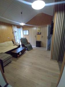 a living room with a bed and a couch at Sosnowy Zakątek, Laskowo in Laskowo