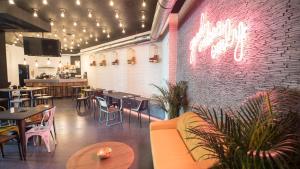 a restaurant with tables and chairs and a brick wall at Koisi Hostel in San Sebastián