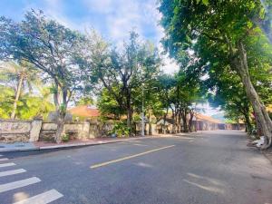 an empty street with trees on the side of the road at Q Song Chi Côn Đảo Hotel in Con Dao +28 photos
