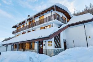 a building covered in snow with snow covered roofs at Residence Nube D'Argento in Sestriere