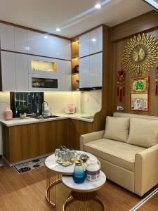 a living room with a couch and a table at Trang Due homestay in An Dương