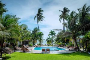 a resort pool with palm trees and lounge chairs at Matie Beach Hotel & Resort in Kao Kuil +15 photos