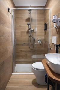 a bathroom with a shower with a toilet and a sink at BEDS&ROOMS TIBURTINA - Beds, Posti letto in Rome