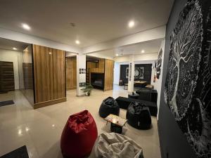a living room with a couch and a table at Dostel in Bhowāli +14 photos