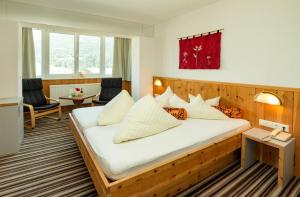 a hotel room with a large bed in a room at Hotel Alpina nature-wellness in Wenns +57 photos