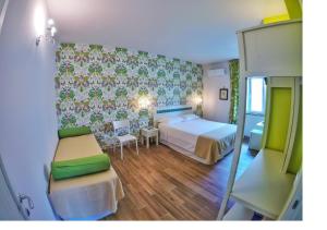 a bedroom with a bed and a table and chairs at Aramoni B&B in Zambrone