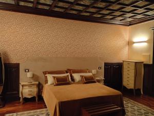 a bedroom with a bed and a dresser at Villa Alliata Relais & Spa in Palermo +16 photos
