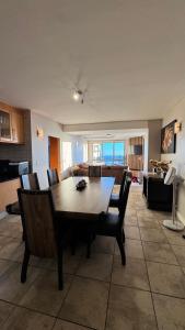 a living room with a wooden table and chairs at Hibernian Towers 1503 in Strand