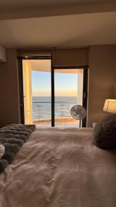 a bedroom with a bed and a view of the ocean at Hibernian Towers 1503 in Strand +31 photos