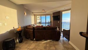 a living room with a couch and a view of the ocean at Hibernian Towers 1503 in Strand