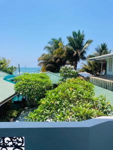 a view of a resort with trees and the ocean at The Villa Hotel in Unawatuna