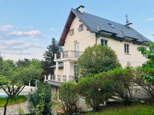 a large white house with a black roof at Caterina.C B&B in Val Della Torre