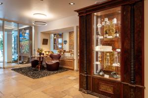 a room with a large wooden display case in a store at Hotel Kreuz & Post Grindelwald in Grindelwald