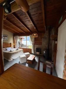 a large room with a bed and a fireplace at Cabañas Walnor in Villa Traful
