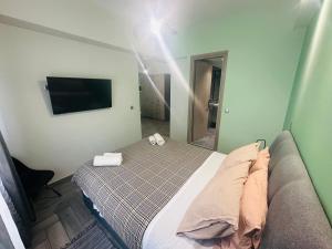 a bedroom with a bed with a mirror and a television at Agatha-2 in Piraeus