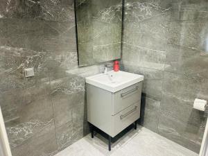 a bathroom with a sink and a mirror at Agatha-2 in Piraeus +26 photos