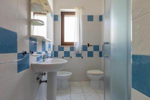 a bathroom with a sink and a toilet at Borgagne Apartment by BarbarHouse in Borgagne