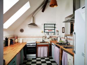 a kitchen with a black and white checkered floor at Noclegi i chleb in Kłopotnica +42 photos