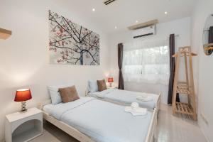 a bedroom with two beds and a painting on the wall at Chaweng Boho Modern in Ban Ko Khwan +14 photos