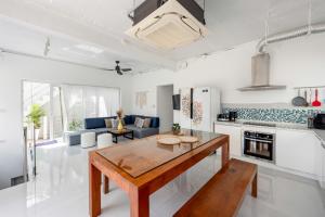 a kitchen and living room with a table in a room at Chaweng Boho Modern in Ban Ko Khwan