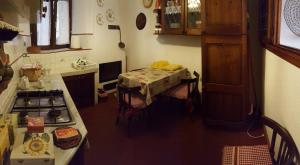 a kitchen with a table and a stove in it at Casa Belvedere in Manarola