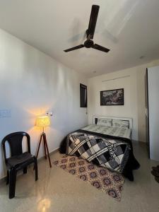 a bedroom with a bed and a ceiling fan at The Cozy Nest in Gurgaon