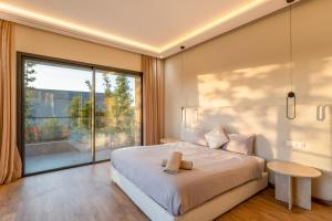 a bedroom with a large bed and a large window at Villa Capella heated pool and cooker in Marrakesh +77 photos