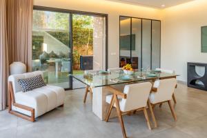 a dining room with a glass table and chairs at Villa Capella heated pool and cooker in Marrakesh