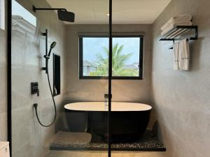 a bathroom with a shower and a bath tub at V3K05A Sonasea Vân Đồn in Quang Ninh