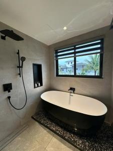 a bath tub in a bathroom with a window at V3K05A Sonasea Vân Đồn in Quang Ninh +7 photos