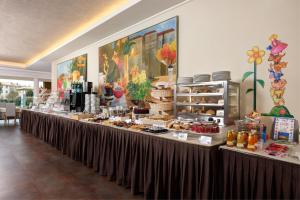 a buffet line with desserts and pastries on display at Best Western Hotel Continental in Udine