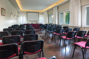 a room with chairs and a screen in it at Best Western Hotel Continental in Udine