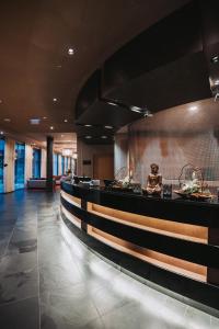 a lobby of a hotel with a long counter at Linsberg Asia Hotel, Spa & Therme - Adults Only in Bad Erlach