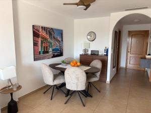 a kitchen and dining room with a table and chairs at Rio Nacimiento in Campoamor